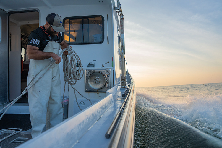 A photo of a man working on a boat