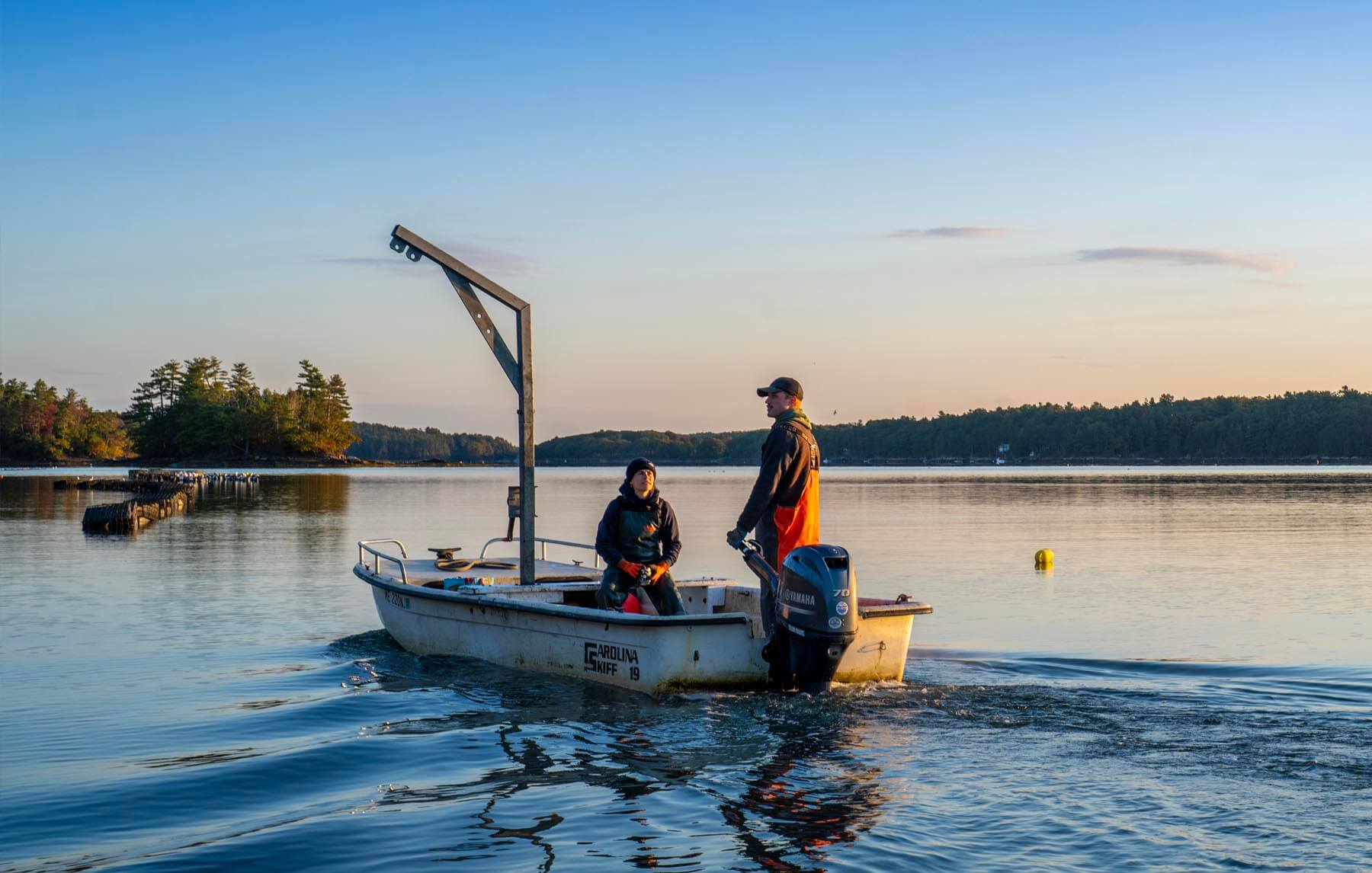 A photo of two people on a boat off the Maine coast
