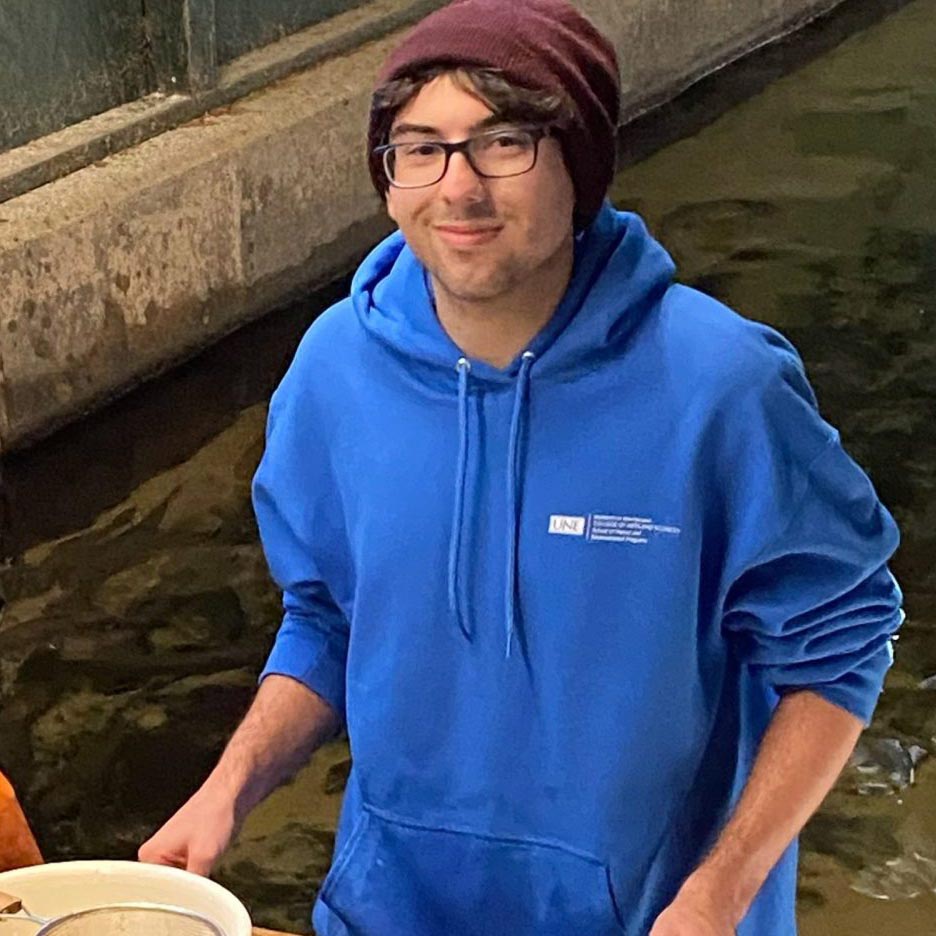 A photo of a person next to a tank of water